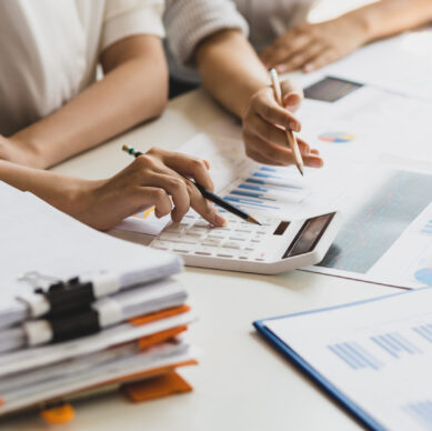 Businesswoman colleague discuss planning, budget management, accounting, business in office.