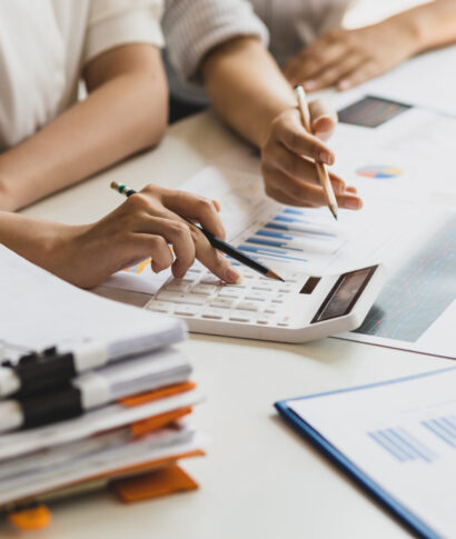 Businesswoman colleague discuss planning, budget management, accounting, business in office.