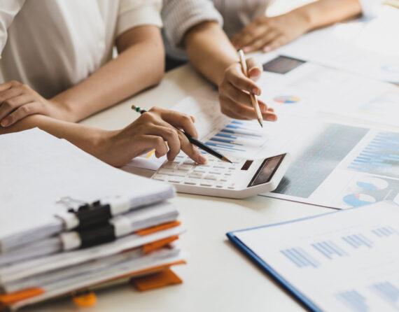 Businesswoman colleague discuss planning, budget management, accounting, business in office.