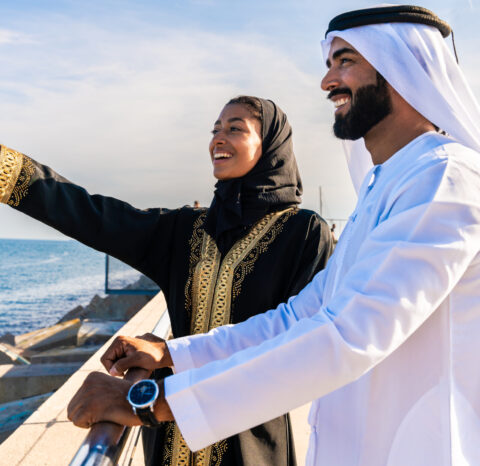 Traditional arab couple wearing emirati clothing dating outdoors Traditional arab couple wearing emirati clothing dating outdoors - Middle-eastern married woman with abaya and man with kandura meeting and having fun in the city