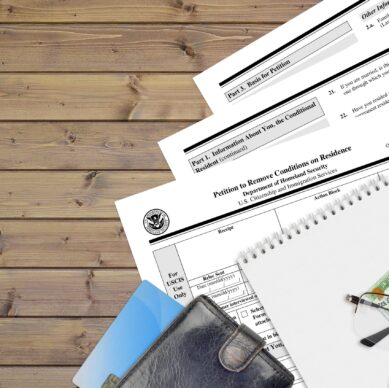 USCIS form I-751 Petition to remove conditions on residence lies on flat lay office table and ready to fill. U.S. Citizenship and Immigration services paperwork concept. Top view