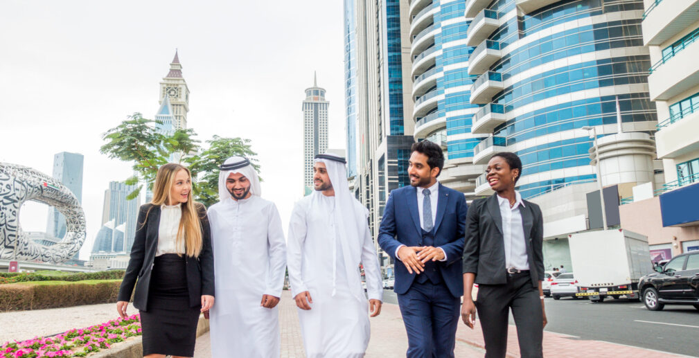 Multi-ethnic group of people on a business meeting in the UAE - Business people walking outdoors and talking about business