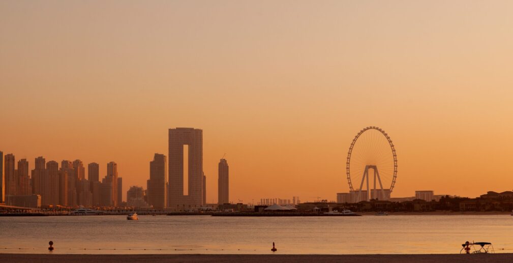 Sunset over the island of Blue Waters with the famous Dubai Eye Ferris wheel.